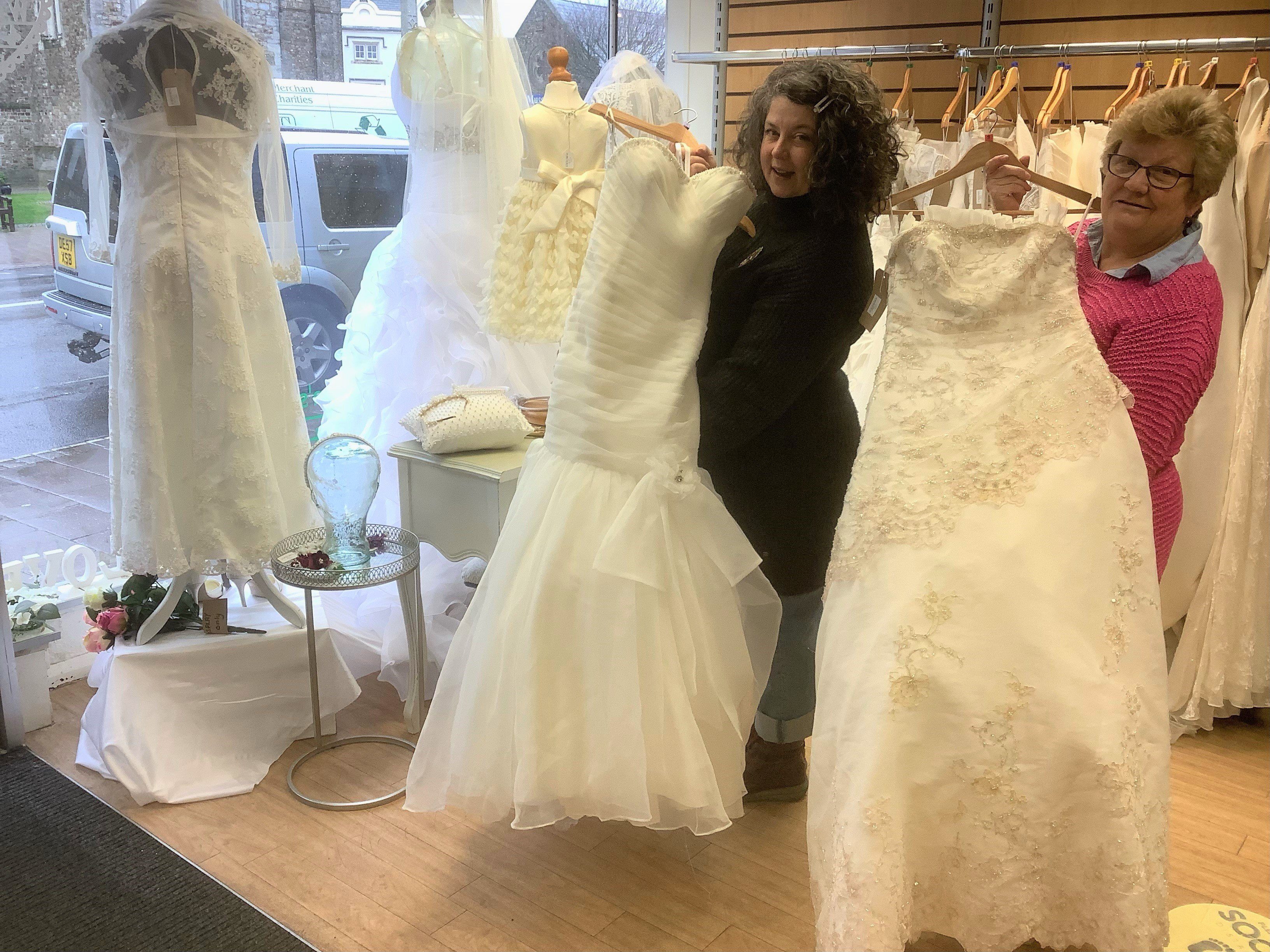 Lynne Whitehall and Emily Thornhill with the wedding dresses in the Honiton Children’s Hospice South West shop