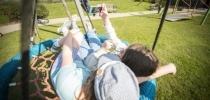 Siblings on swing with phone thumbnail