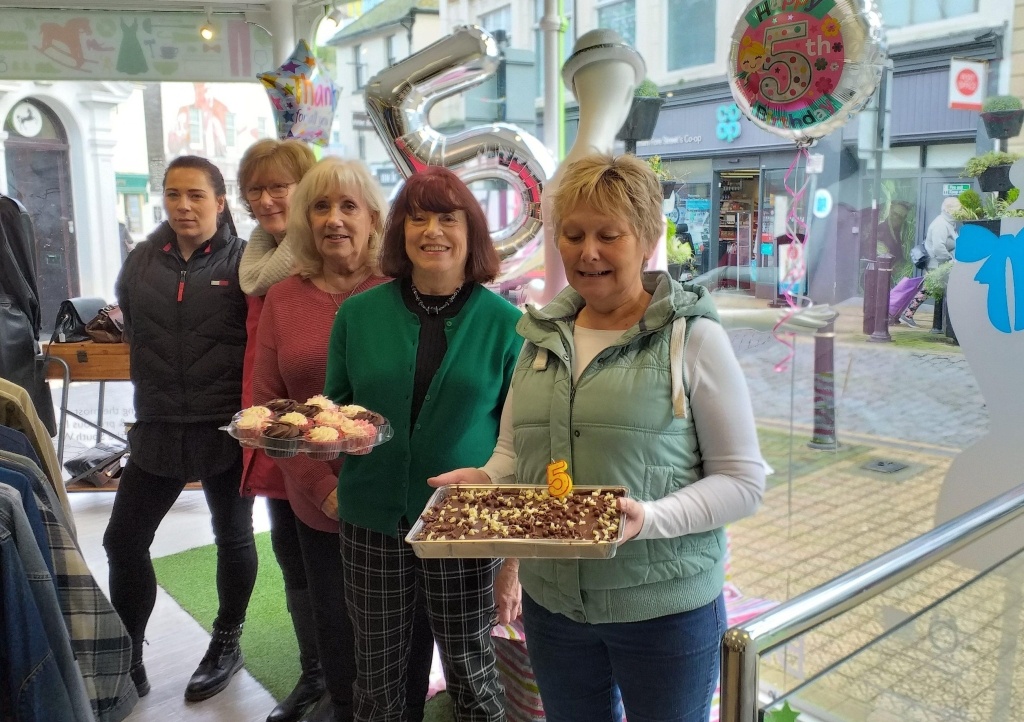 Staff and volunteers celebrate the Brixham’s shop’s fifth birthday