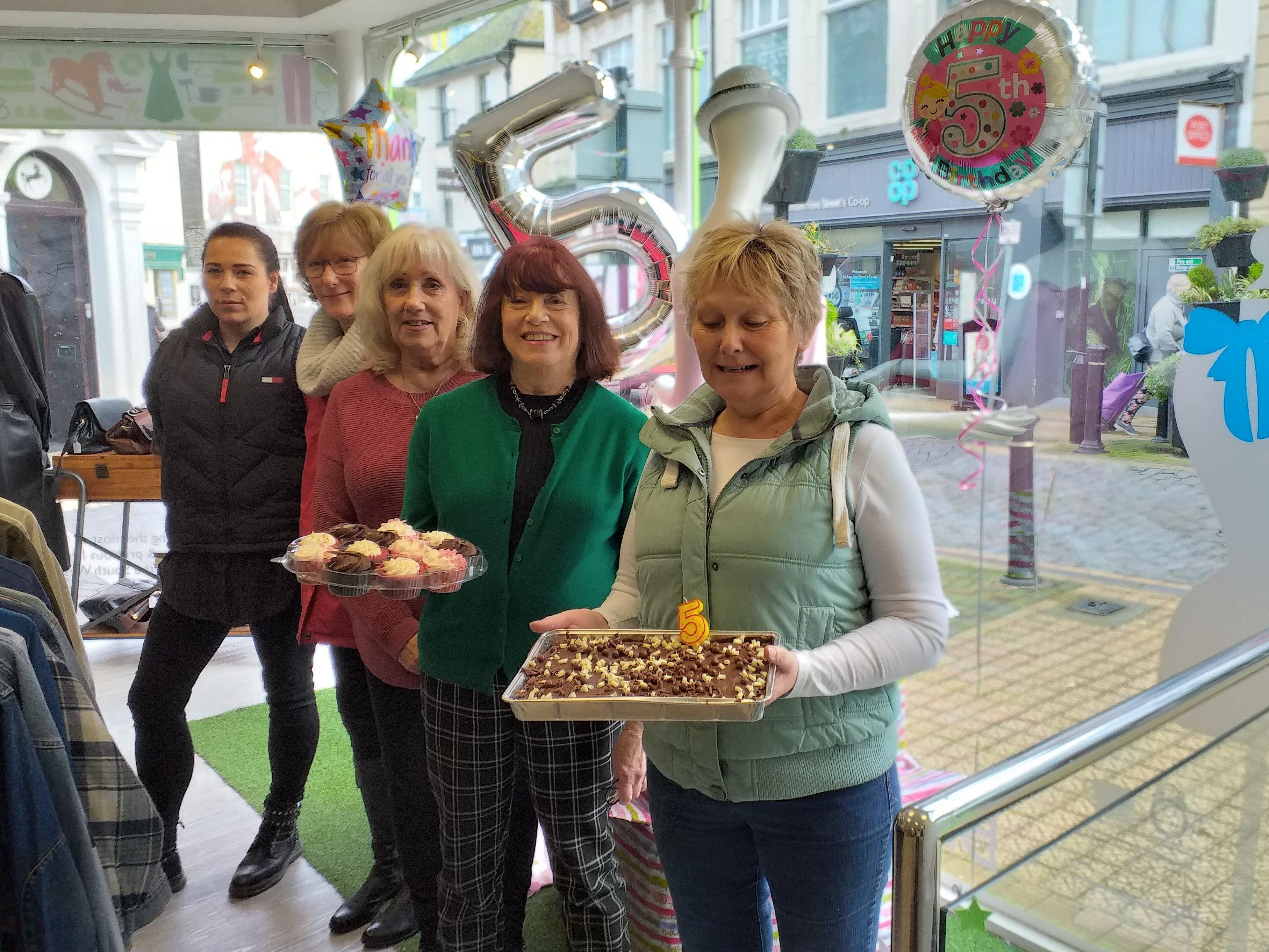 Staff and volunteers celebrate the Brixham’s shop’s fifth birthday