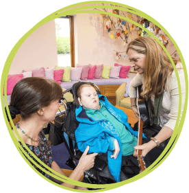 Barnstaple teenager Sam enjoying a music therapy session at Little Bridge House with mum Jo and the hospice’s music therapist Ceridwen Rees. 