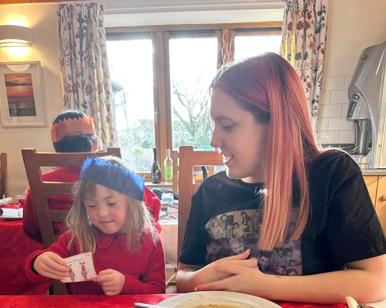 Esme and her sister enjoying Christmas lunch together at the hospice