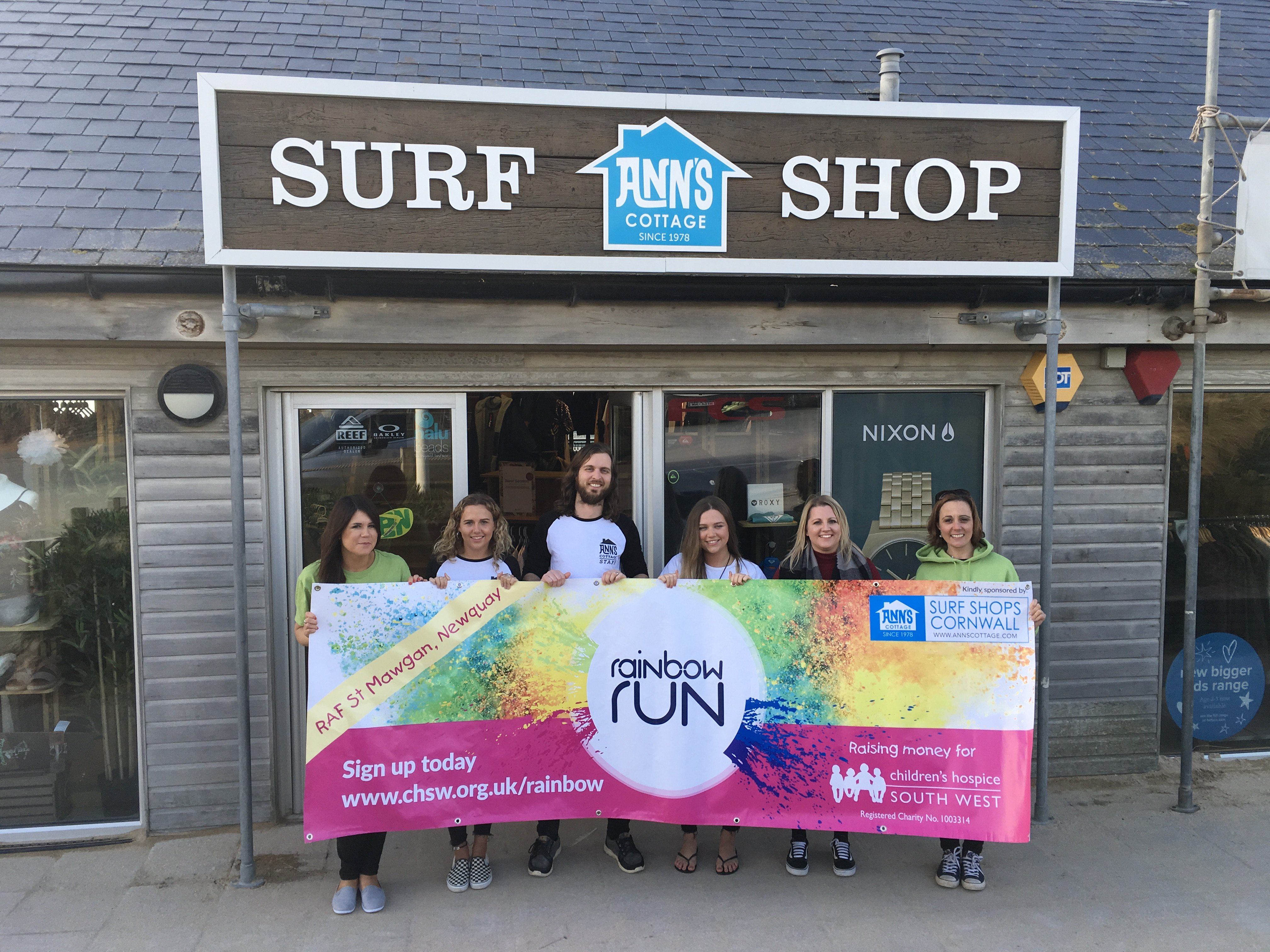 Ann's Cottage and CHSW staff launch their partnership for the Rainbow Run with a photo at the Anns Cottage store on Fistral beach