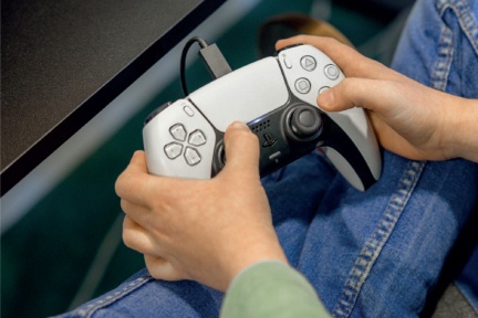 Hands holding a gaming controller