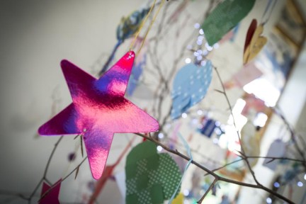 Pink star dedication hanging on a memory tree