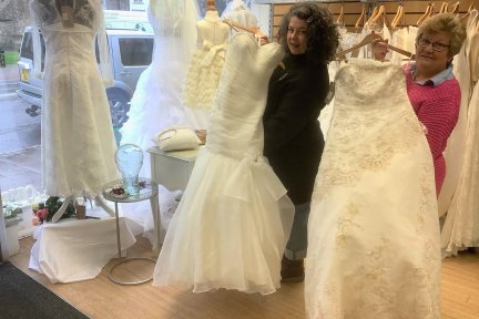 Lynne Whitehall and Emily Thornhill with the wedding dresses in the Honiton CHSW shop