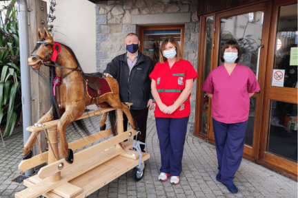 John handing over the rocking horse to Nikki and Linda at Little Harbour