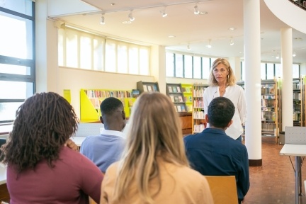 Teacher with students in library
