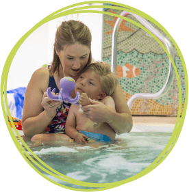 Boy with mum in hydrotherapy pool