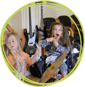 Two sisters in a music therapy session