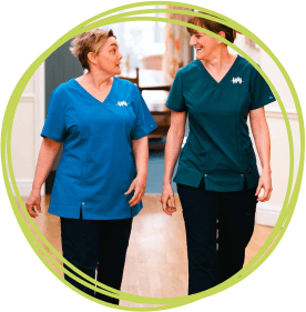 Two nurses walking down a corridor