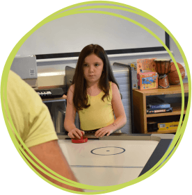 Isla playing air hockey