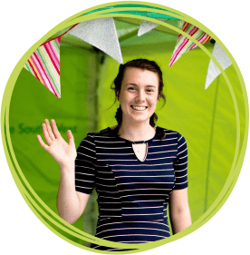 Smiling female volunteer looking at the camera and waving CHSW Volunteer
