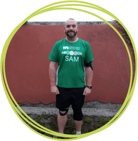 Man in green tshirt standing in garden