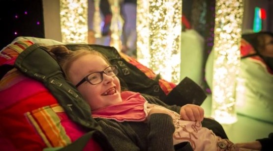 girl smiling in sensory room