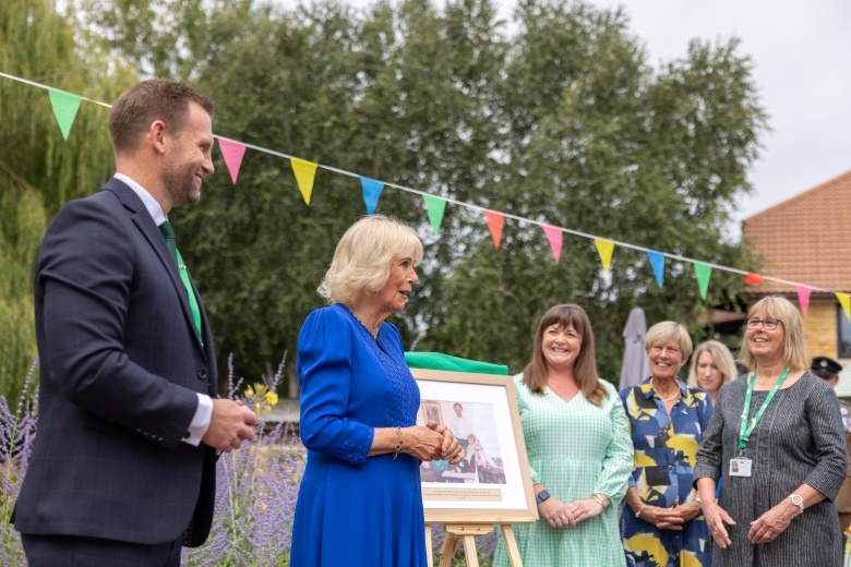 Her Majesty The Queen alongside Phil Morris and Lizzie Farwell 
