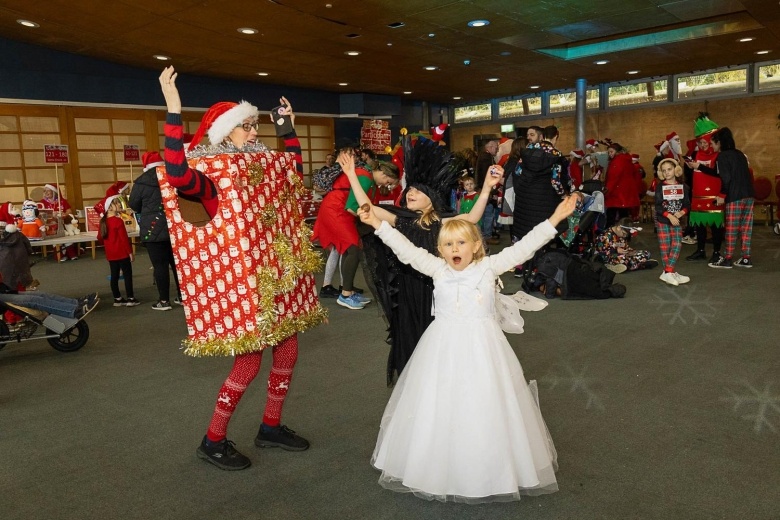 A family at Santas on the Run Eden Project dressed as a fairy and a present