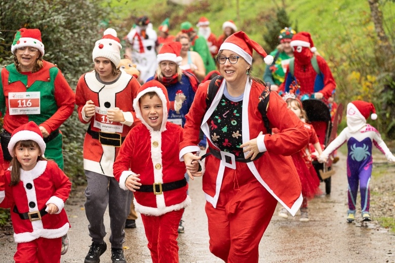 A family at Santas on the Run Eden Project dressed in santa suits