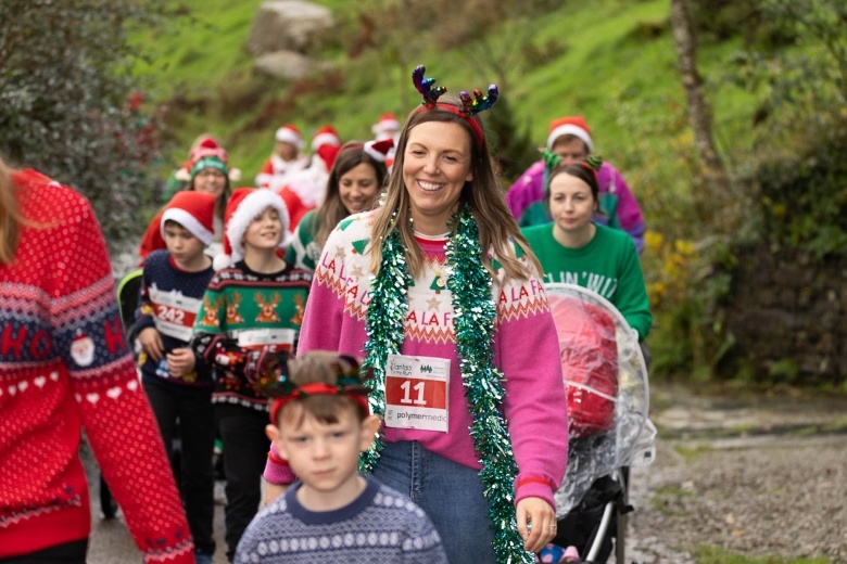 A woman at Santas on the Run Eden Project in a Christmas jumper