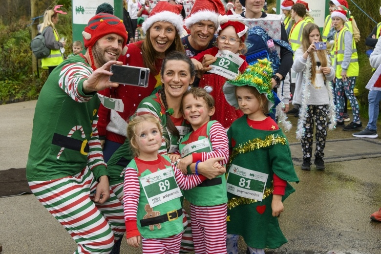 A family in festive fancy dress taking a selfie