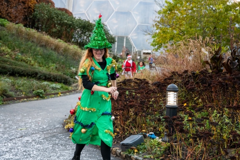 Woman taking part in Santas on the Run Eden Project dressed as a Christmas Tree