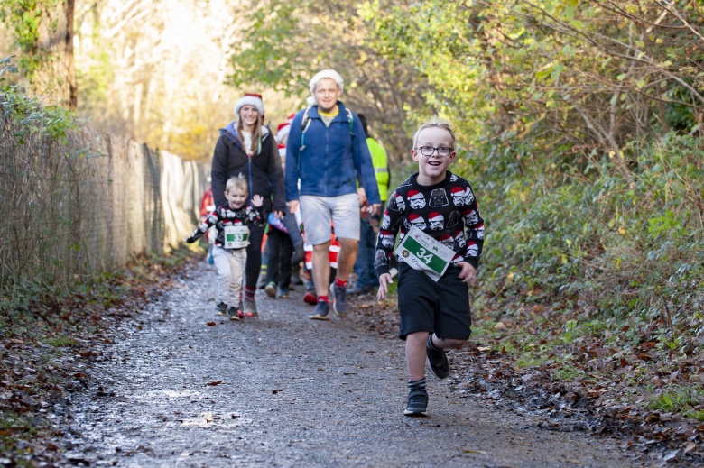 Child running fast in the santa run