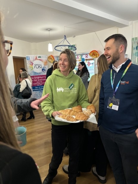 Fundraiser handing out a tray of croissants at the Business Breakfast