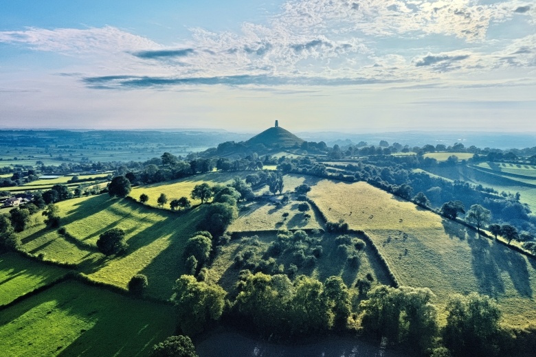 drone shot of Glastonbury Tor in the distance