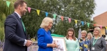 Her Majesty The Queen alongside Phil Morris and Lizzie Farwell  thumbnail