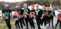 A family at Santas on the Run Eden Project dressed as Merry Christmas thumbnail