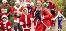 A family at Santas on the Run Eden Project dressed in santa suits thumbnail