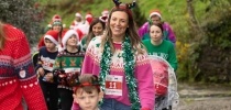 A woman at Santas on the Run Eden Project in a Christmas jumper thumbnail