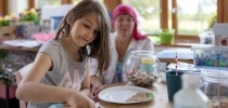 siblings in messy play with carer thumbnail