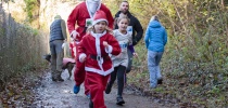 Two people dressed in santas suits running thumbnail