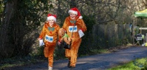 Two people dressed as reindeers in the santas run thumbnail
