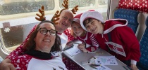 Family in christmas pyjamas on the santa train thumbnail