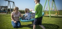 Sibling and carer playing in Little Harbour garden thumbnail