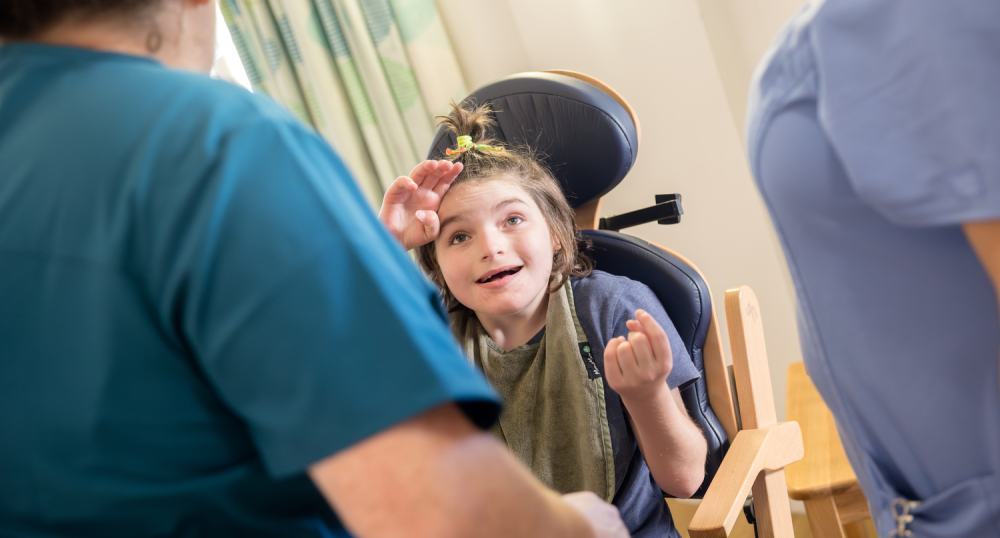 Girl smiling with carers