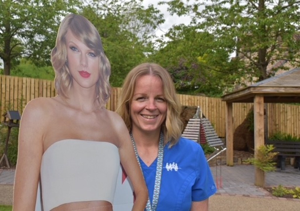 Nurse with cardboard cut out of Taylor Swift