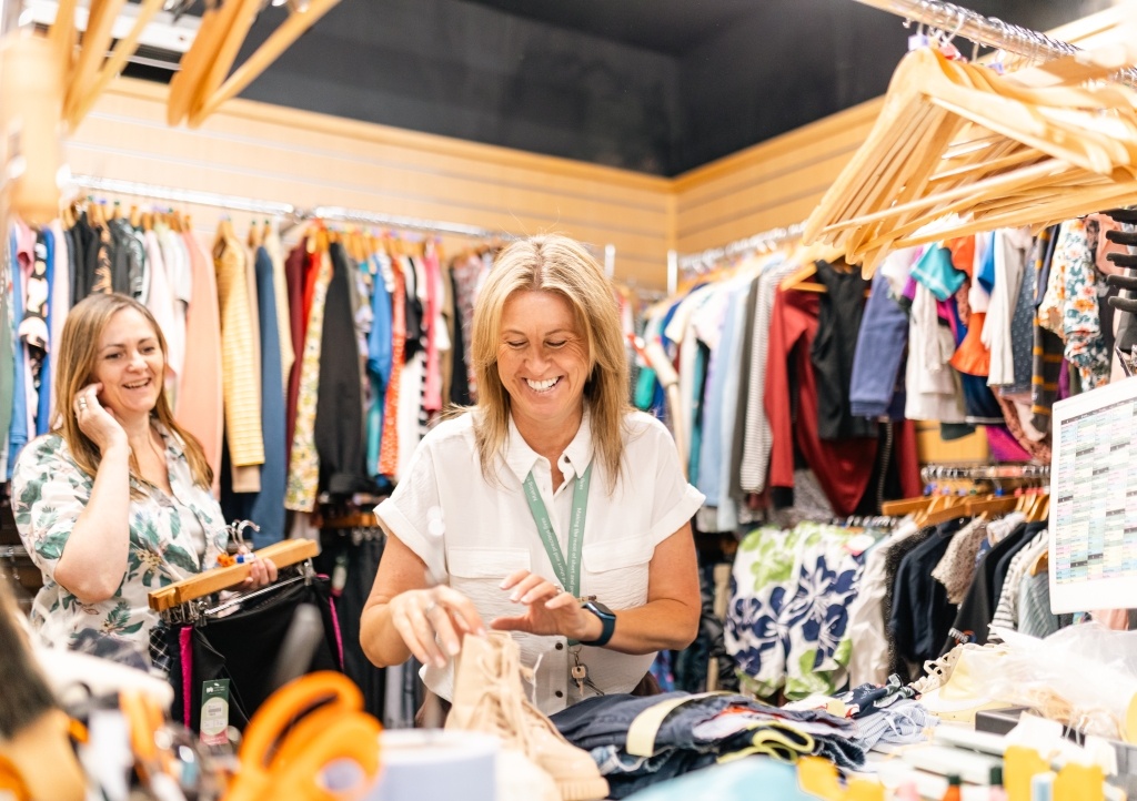 Shop staff member sorting stock donations