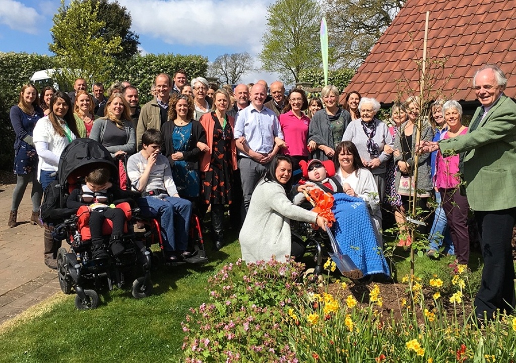 Celebration tree planting ceremony at Charlton Farm with families and staff members