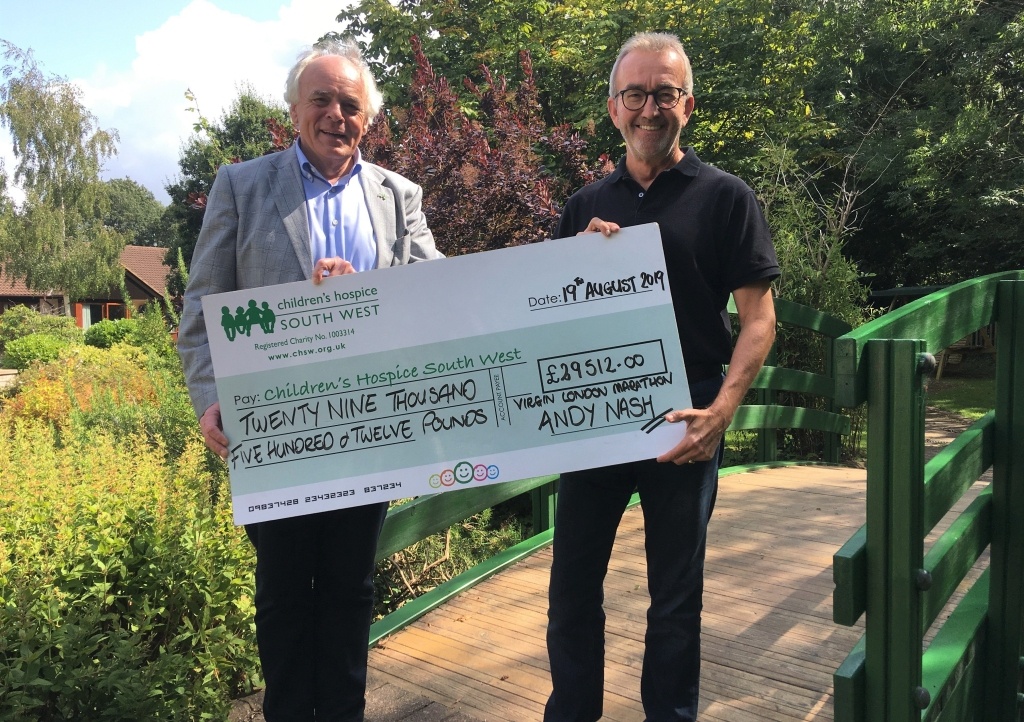 Andy Nash presents his fundraising cheque to CHSW's co-founder and chief executive Eddie Farwell
