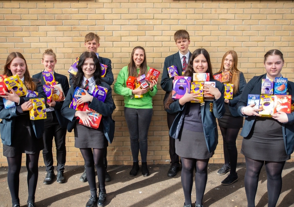 Year 10 Bishop Fox's students present the eggs to CHSW area fundraiser Mary Gray