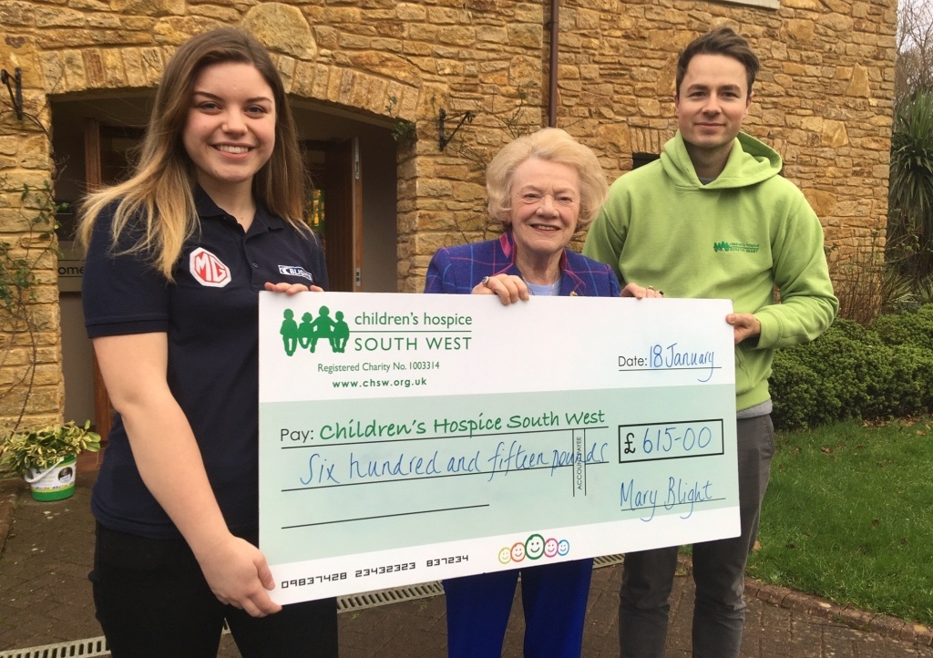 Mary Blight and Blights Motors service advisor Hannah Esau present the fundraising cheque to Children’s Hospice South West community fundraiser Josh Allan at Little Bridge House in Fremington.