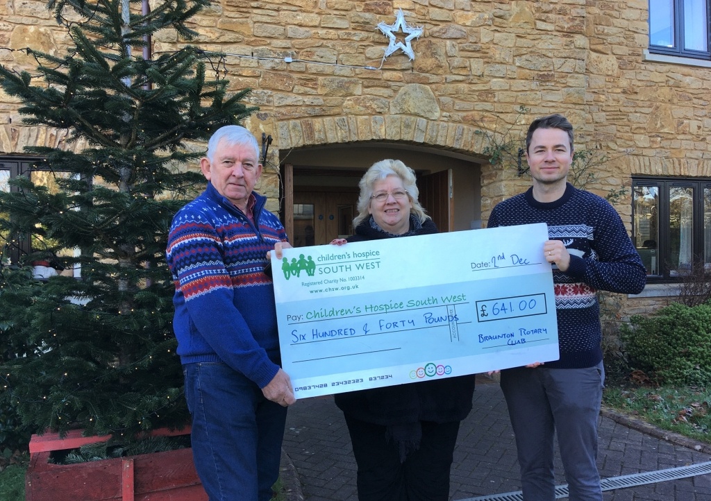 Braunton Rotary Club members Ian Welsh and Beryl Lloyd present the fundraising cheque to CHSW community fundraiser Josh Allen