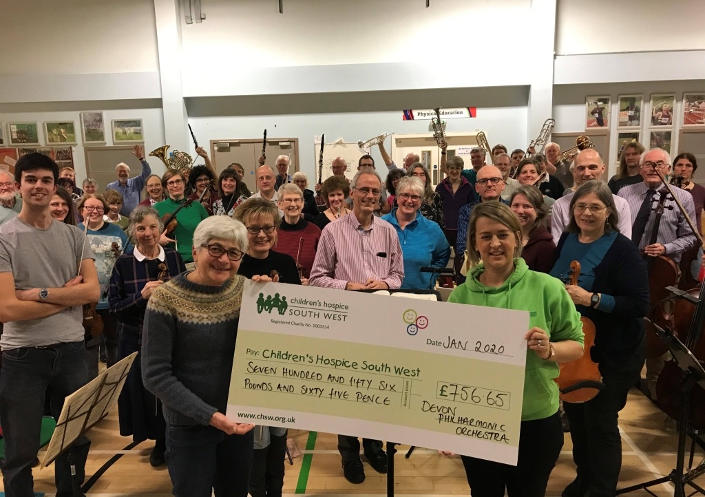 Members of the Devon Philharmonic Orchestra present the money raised