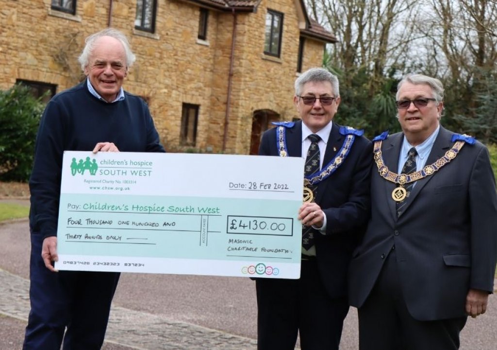 Devonshire Provincial Grand Master Ian Kingsbury and assistant Charles Yelland present the grant cheque to CHSW Chief Executive and Co-founder Eddie Farwell at Little Bridge house. Pic: CHSW