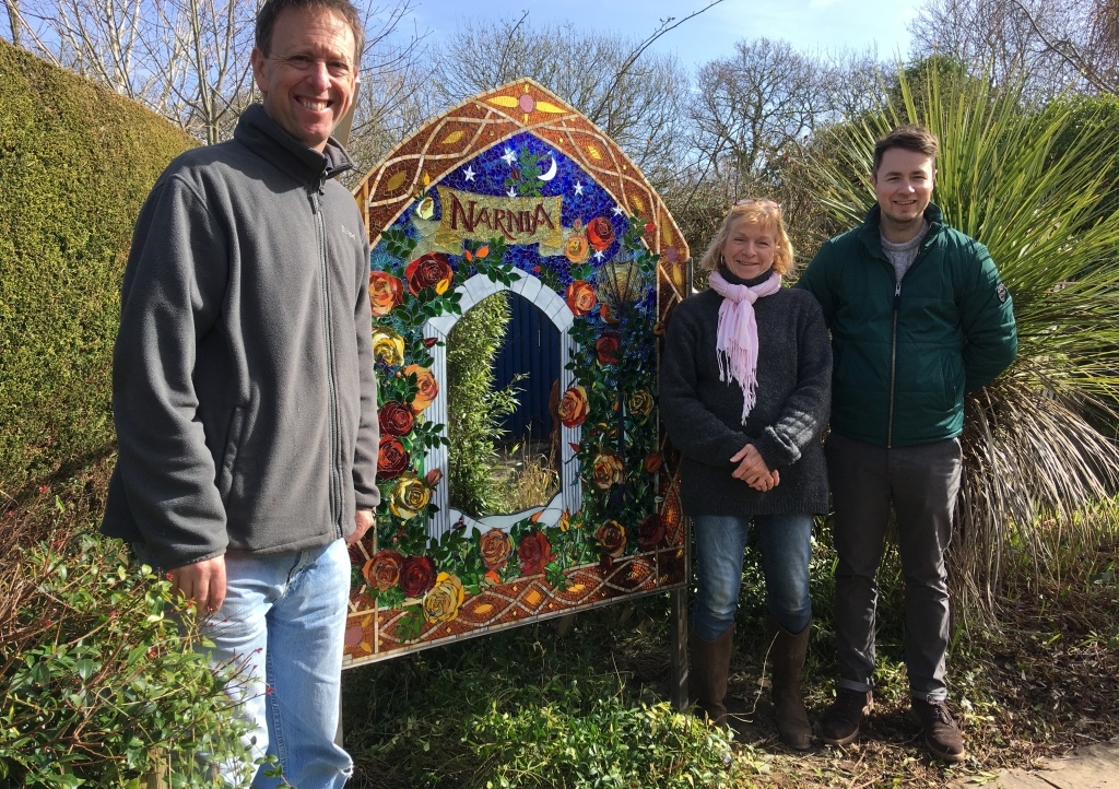 Little Bridge House Maintenance Manager Gary Hatch and Community Fundraiser Josh Allen unveil the new mirror with artist Sue Smith