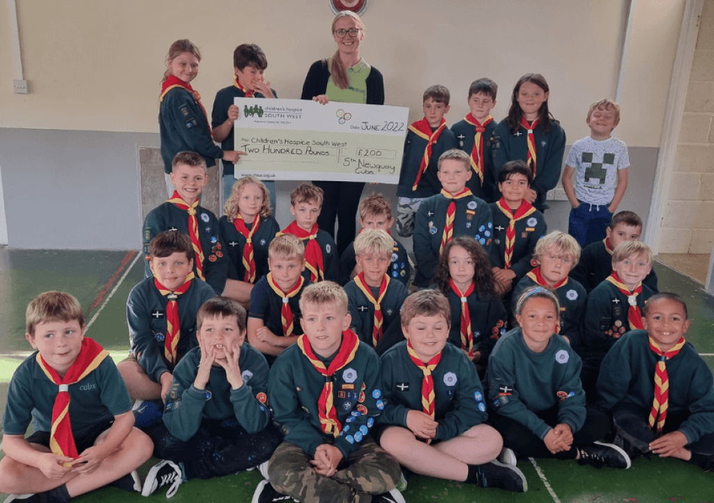 Newquay Cub Scouts gather for a cheque presentation to Alice from CHSW