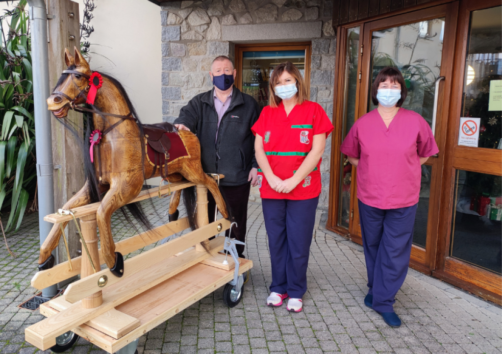 John handing over the rocking horse to Nikki and Linda at Little Harbour
